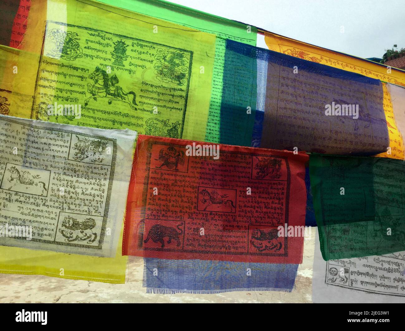 Nepalese prayer flags,  inscribed with auspicious symbols, invocations, prayers, and mantras, put at places of spiritual practice in Himalayas. Stock Photo