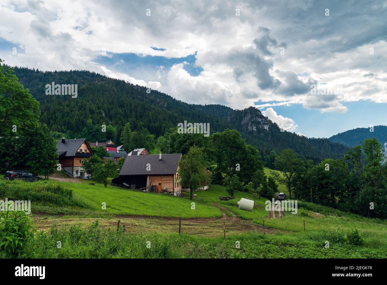 Podrozsutec hamlet bellow Maly Rozsutec hill in Mala Fatra mountains in Slovakia during summer day with blue sky and clouds Stock Photo