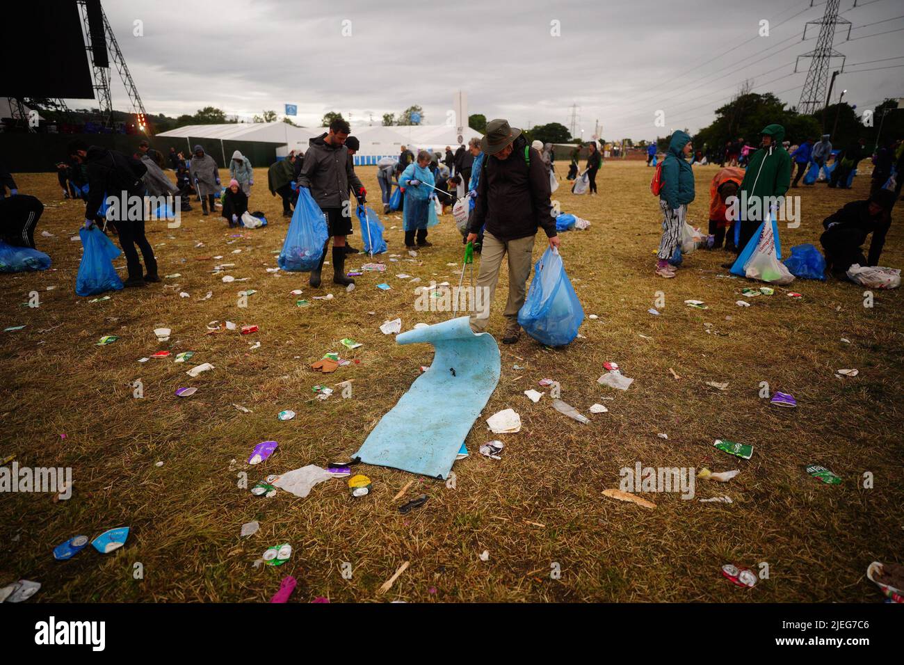 Litter pickers work to clear Worthy Farm in Somerset following the