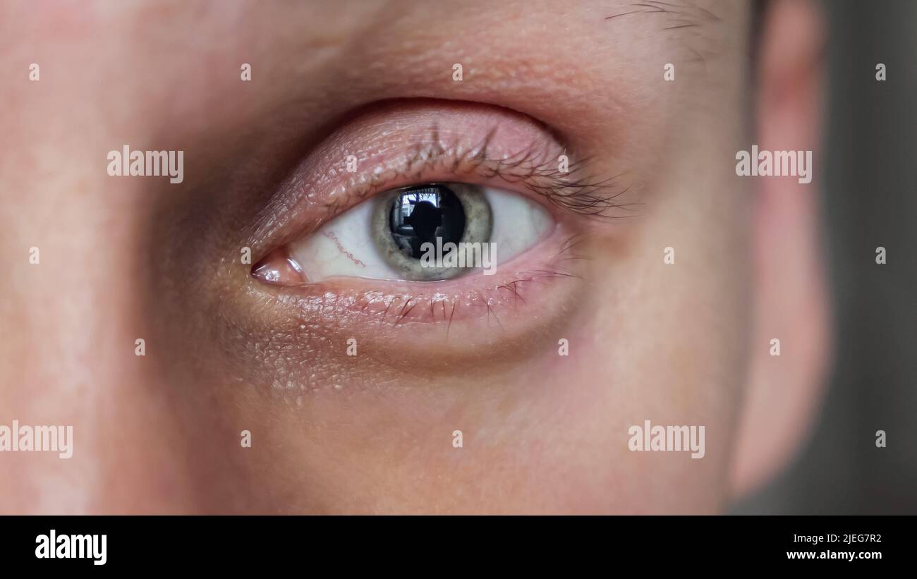 Mature man opens eyes looking straight in camera macro Stock Photo