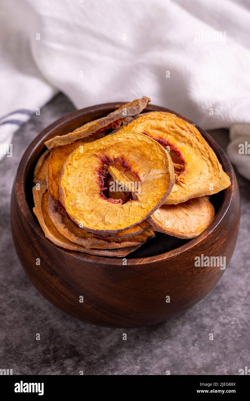 Dried peach slices. Sliced dried peaches on a dark background. Sun