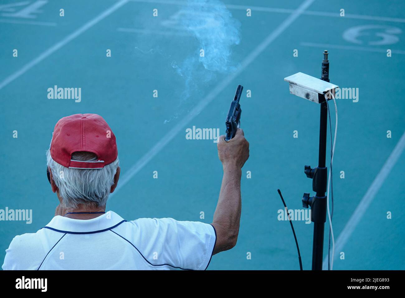 Starting pistol being fired. Hand firing a gun for starting race. Milan, Italy June 2022 Stock