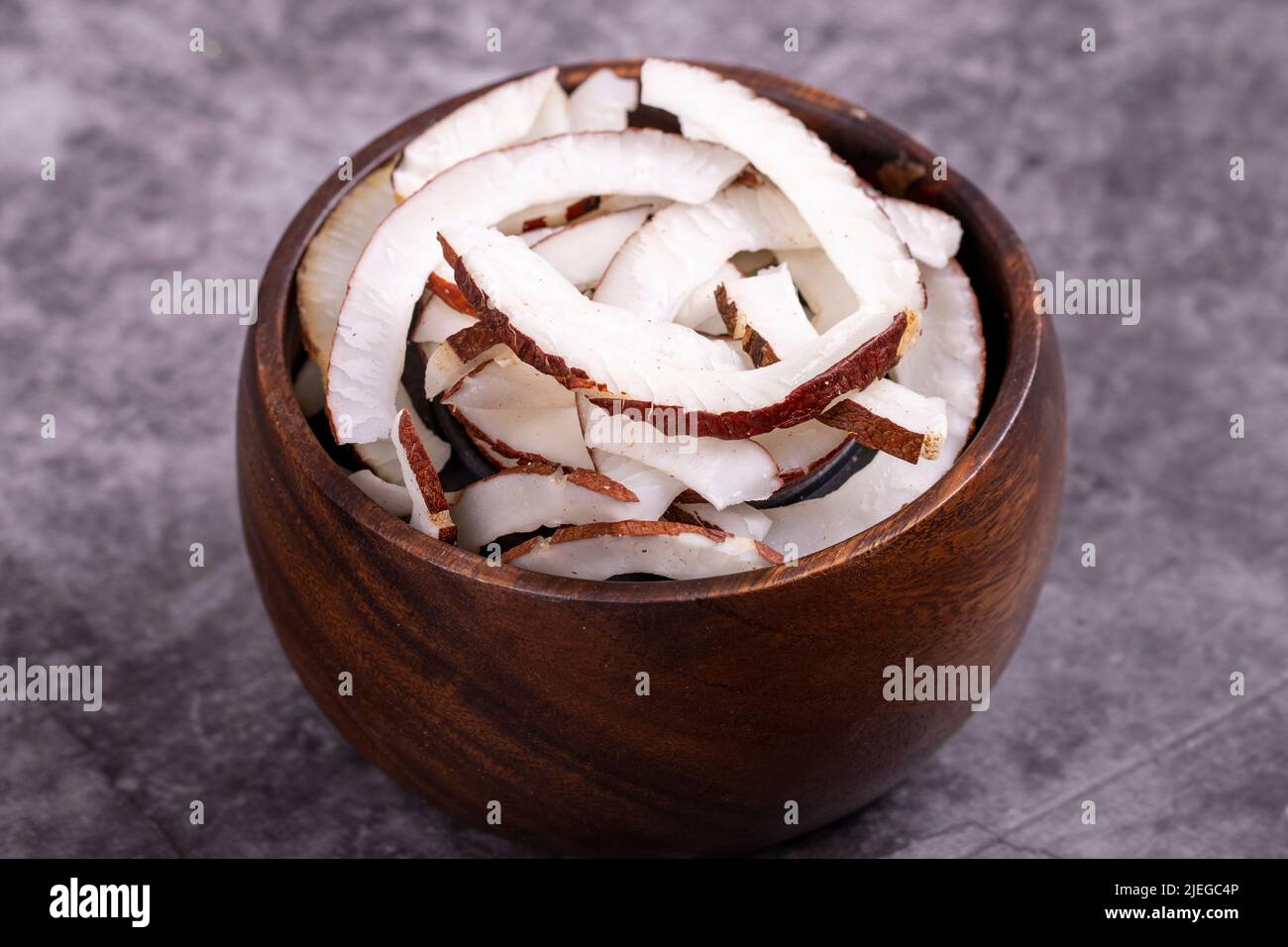 Dried coconut slices. Sliced dry coconut on dark background. Sundried