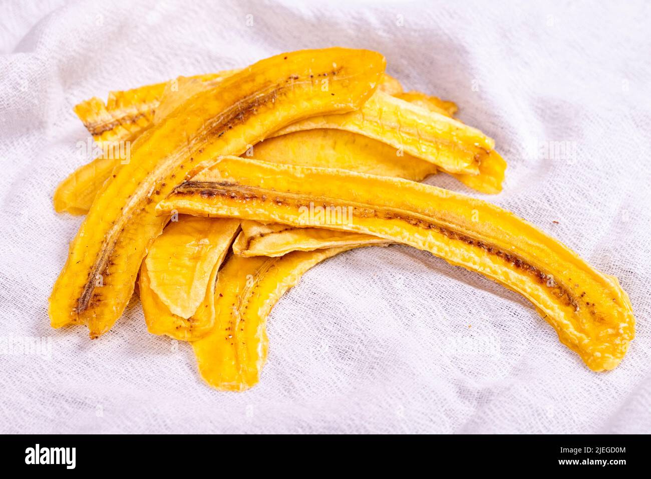 Dried banana slices. Sliced dried banana on white background. Sundried