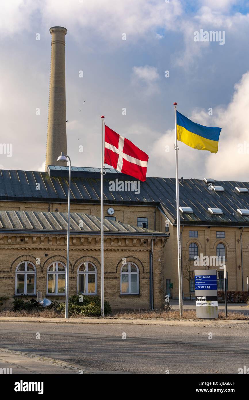 The flags of Denmark and Ukraine fly in front of the town hall building in the old Assens sugar factory. Assens, Denmark, Europe Stock Photo