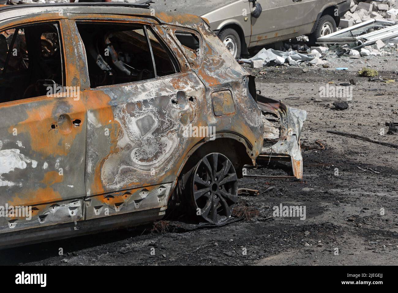 A burnt-out car is seen in the yard of an apartment block after the shelling of a northern neighbourhood by Russian troops with a BM-30 Smerch multiple rocket launcher, Kharkiv, northeastern Ukraine, June 26, 2022. Photo by Vyacheslav Madiyevskyy/Ukrinform/ABACAPRESS.COM Stock Photo