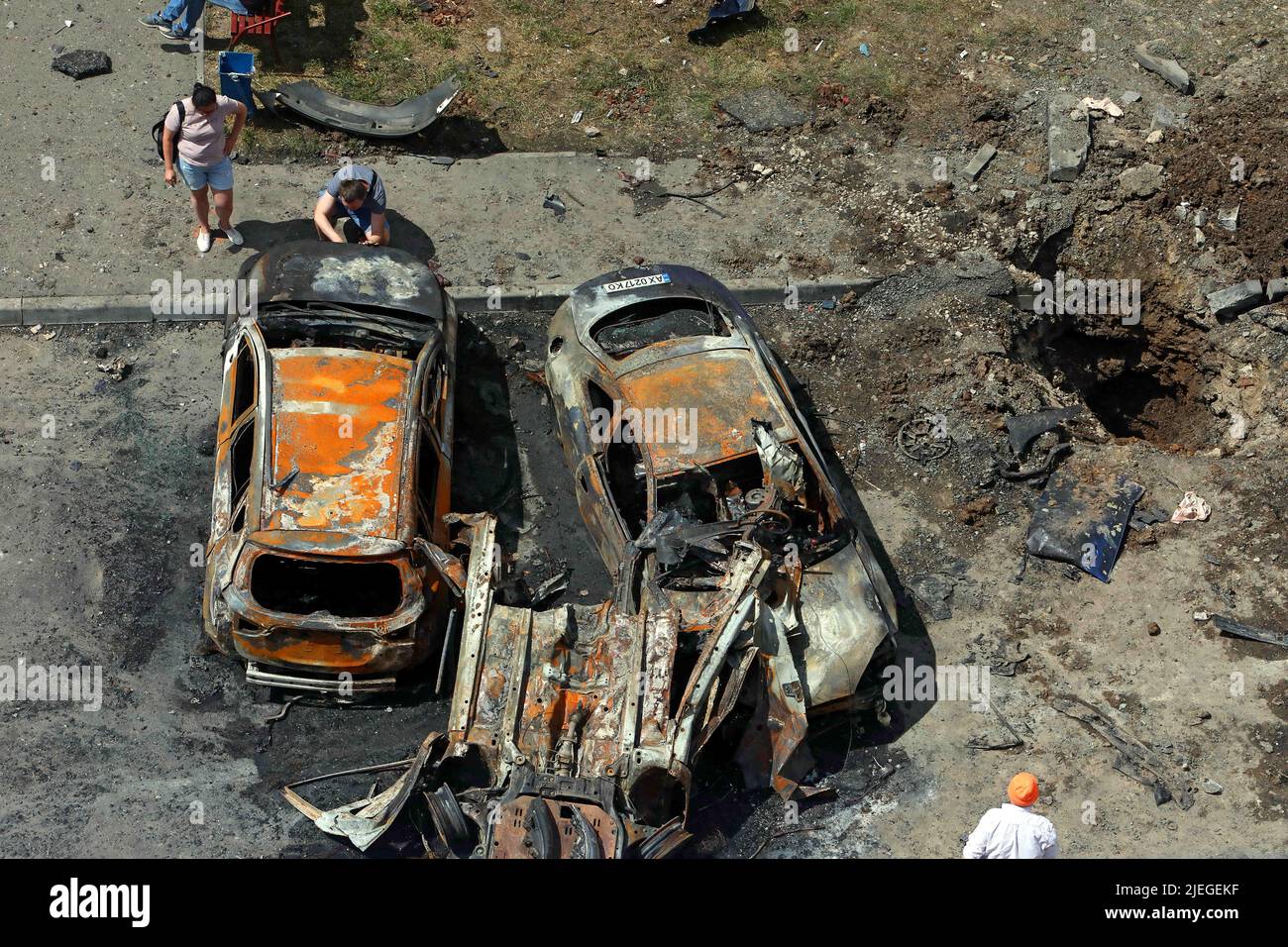 A crater is seen in the ground near burnt-out cars after the Russian troops attacked a northern neighbourhood with a BM-30 Smerch multiple rocket launcher, Kharkiv, northeastern Ukraine, June 26, 2022. Photo by Vyacheslav Madiyevskyy/Ukrinform/ABACAPRESS.COM Stock Photo