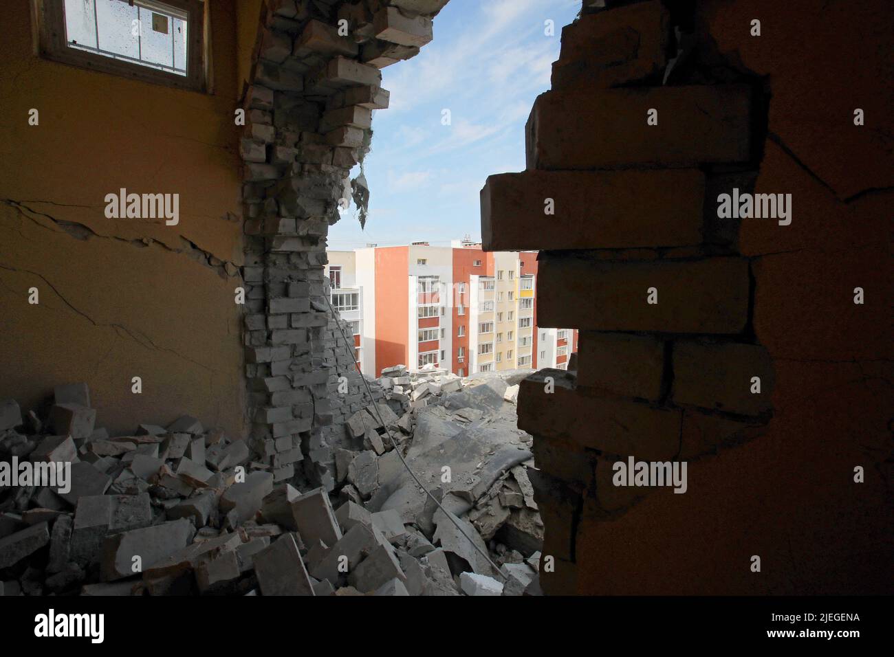 An apartment block is seen through a hole in the wall after the Russian troops shelled a northern neighbourhood with a BM-30 Smerch multiple rocket launcher, Kharkiv, northeastern Ukraine, June 26, 2022. Photo by Vyacheslav Madiyevskyy/Ukrinform/ABACAPRESS.COM Stock Photo