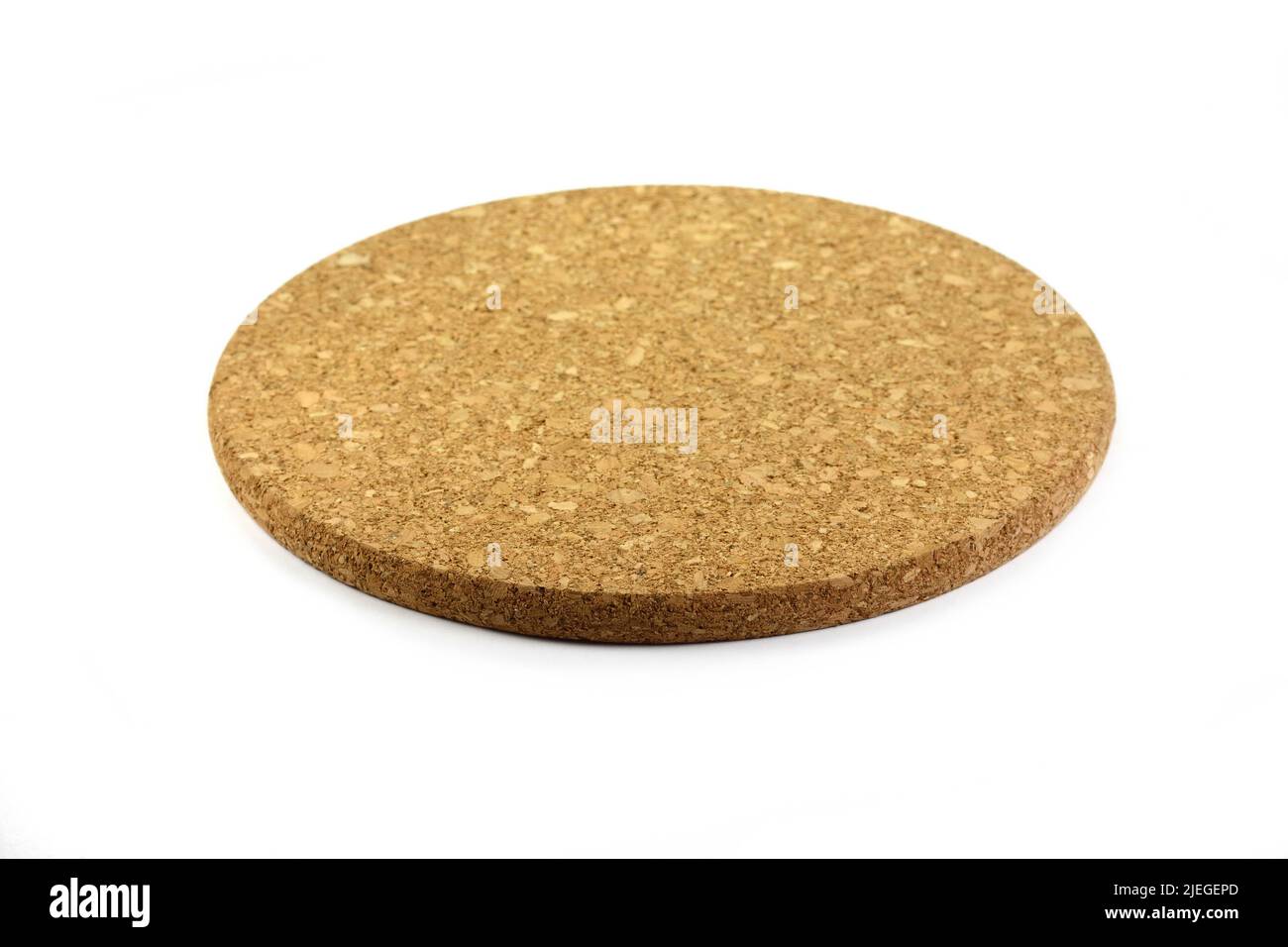 Empty round cork coaster, isolated on white background. Stock Photo