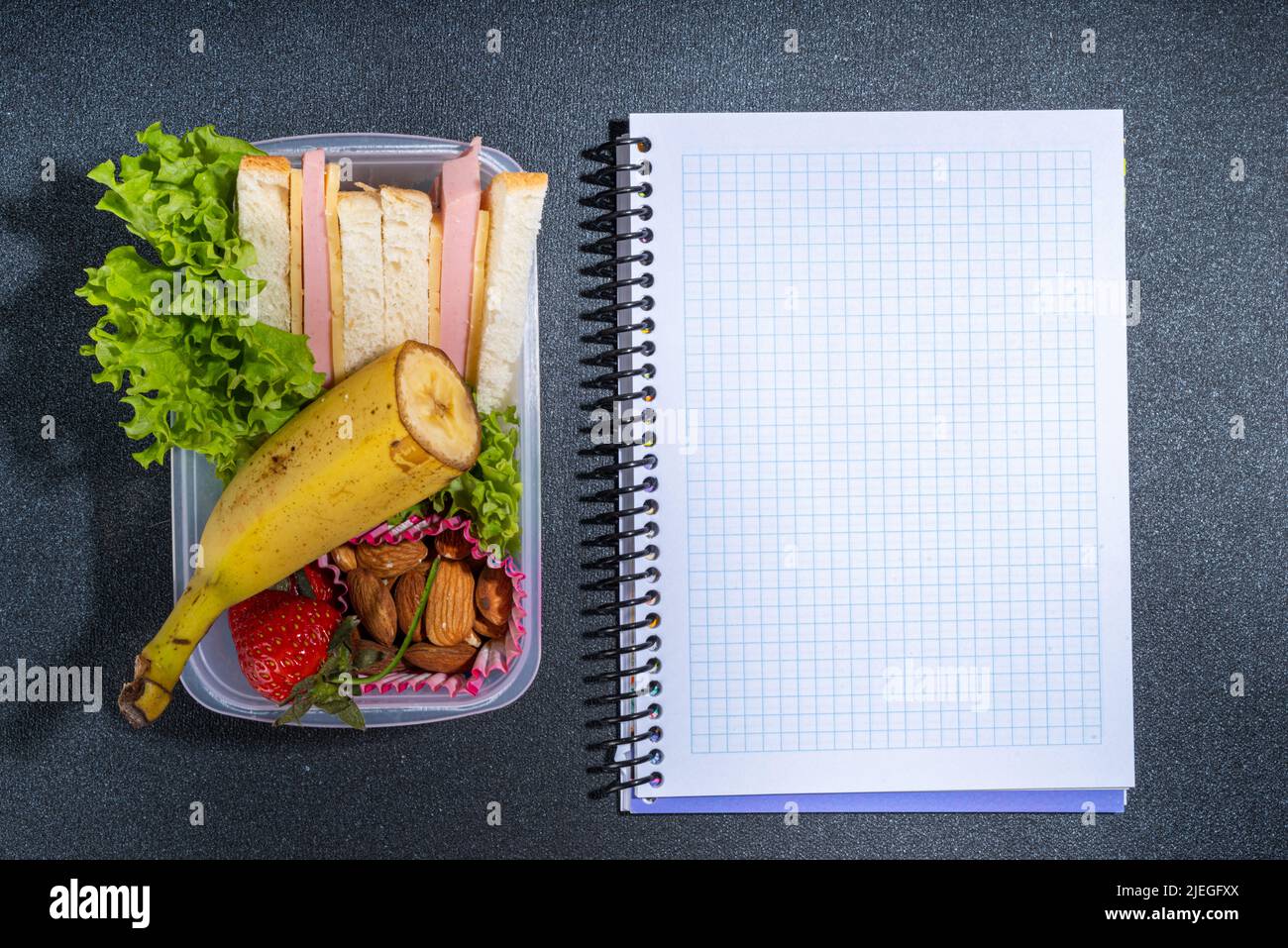 Healthy school lunch box sandwich, vegetables, fruit, nuts and yogurt