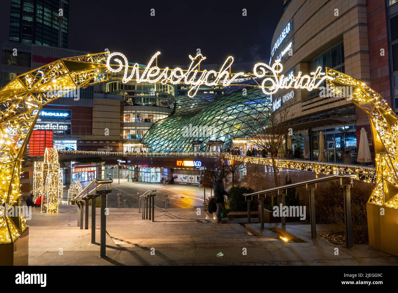 Warsaw, Poland - December 14, 2020: Zlote Tarasy (Golden Terraces) shopping mall and entertainment complex at night in the city center during winter h Stock Photo
