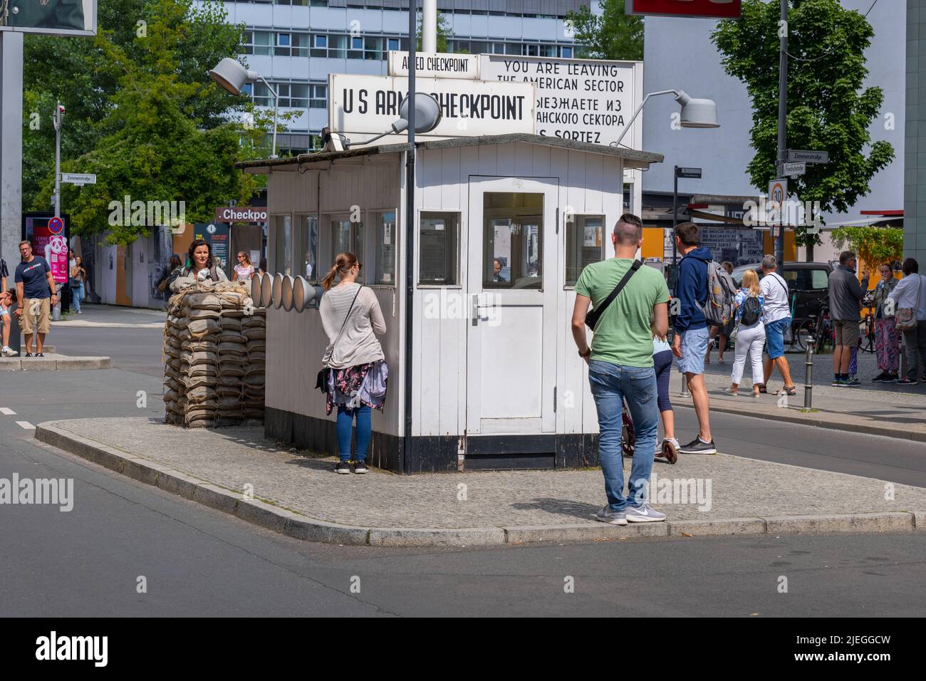 Berlin, Germany - August 4, 2021: People at the Checkpoint Charlie, old Berlin Wall crossing point between East and West Berlin, city landmar Stock Photo