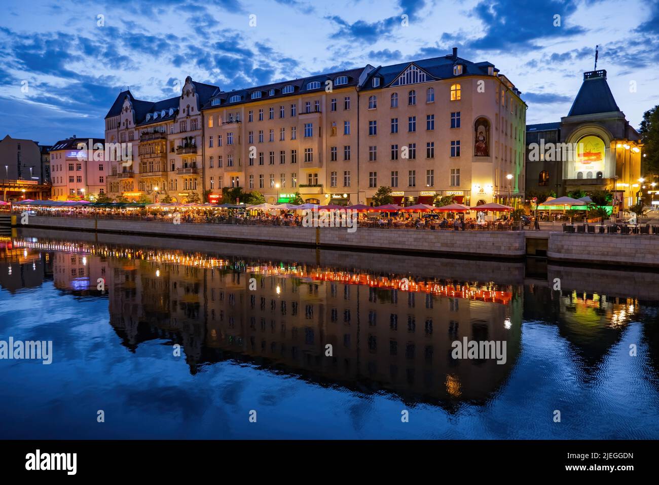 Berlin, Germany - August 8, 2021: City center with River Spree in the evening, riverside buildings on Schiffbauerdamm street with restaurants, cafes i Stock Photo
