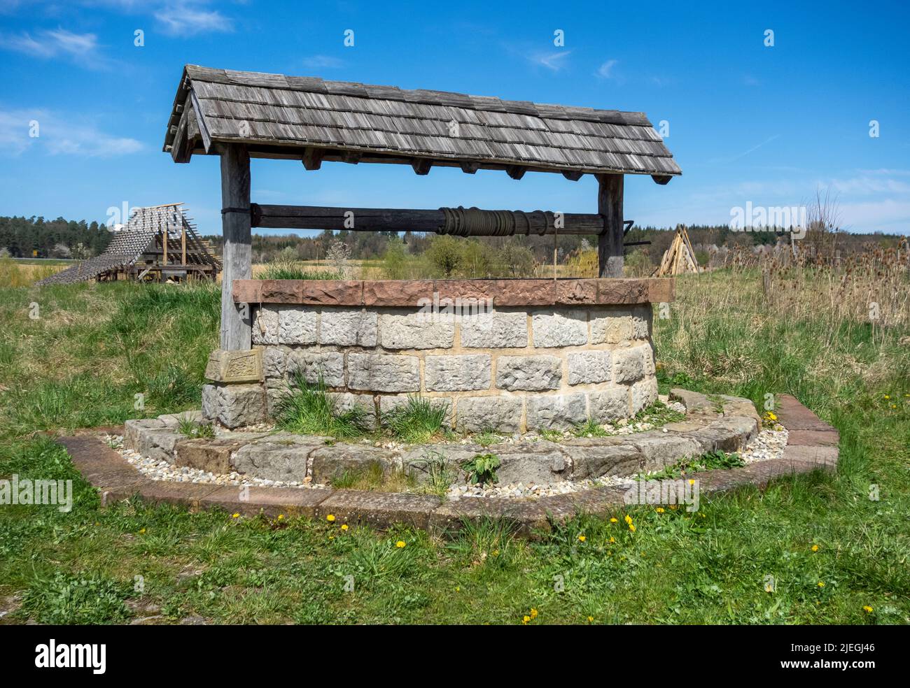 Medieval draw well in sunny ambiance at early spring time Stock Photo