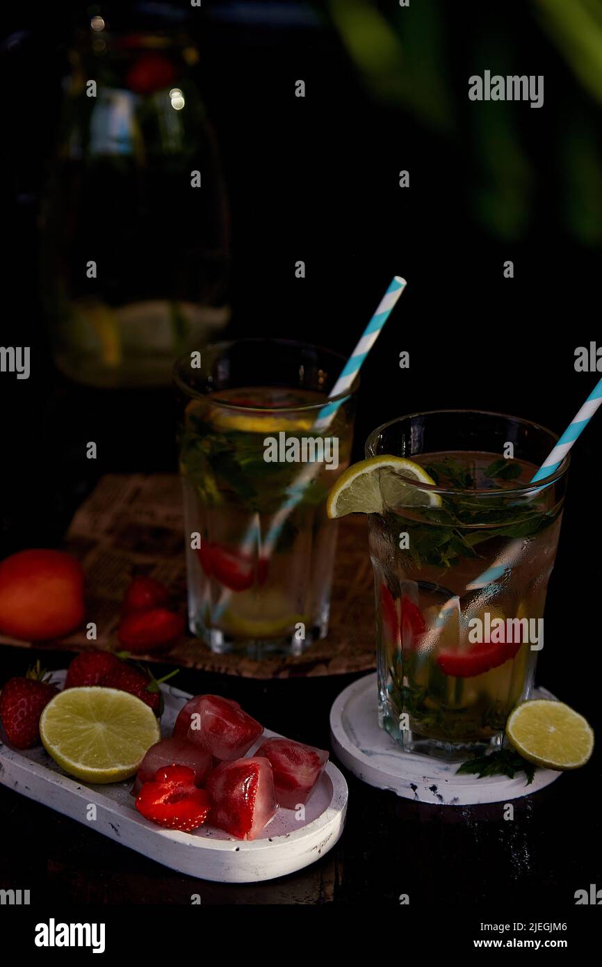 Summer infused water with lemon, lime, mint and strawberry ice