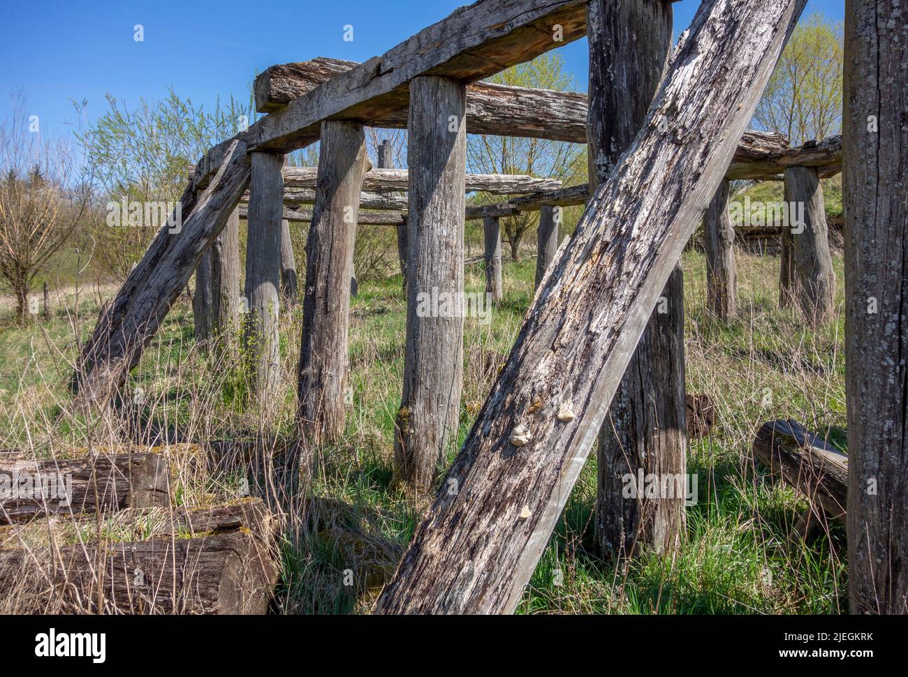 Rundown medieval wooden building remains in sunny ambiance at early spring time Stock Photo