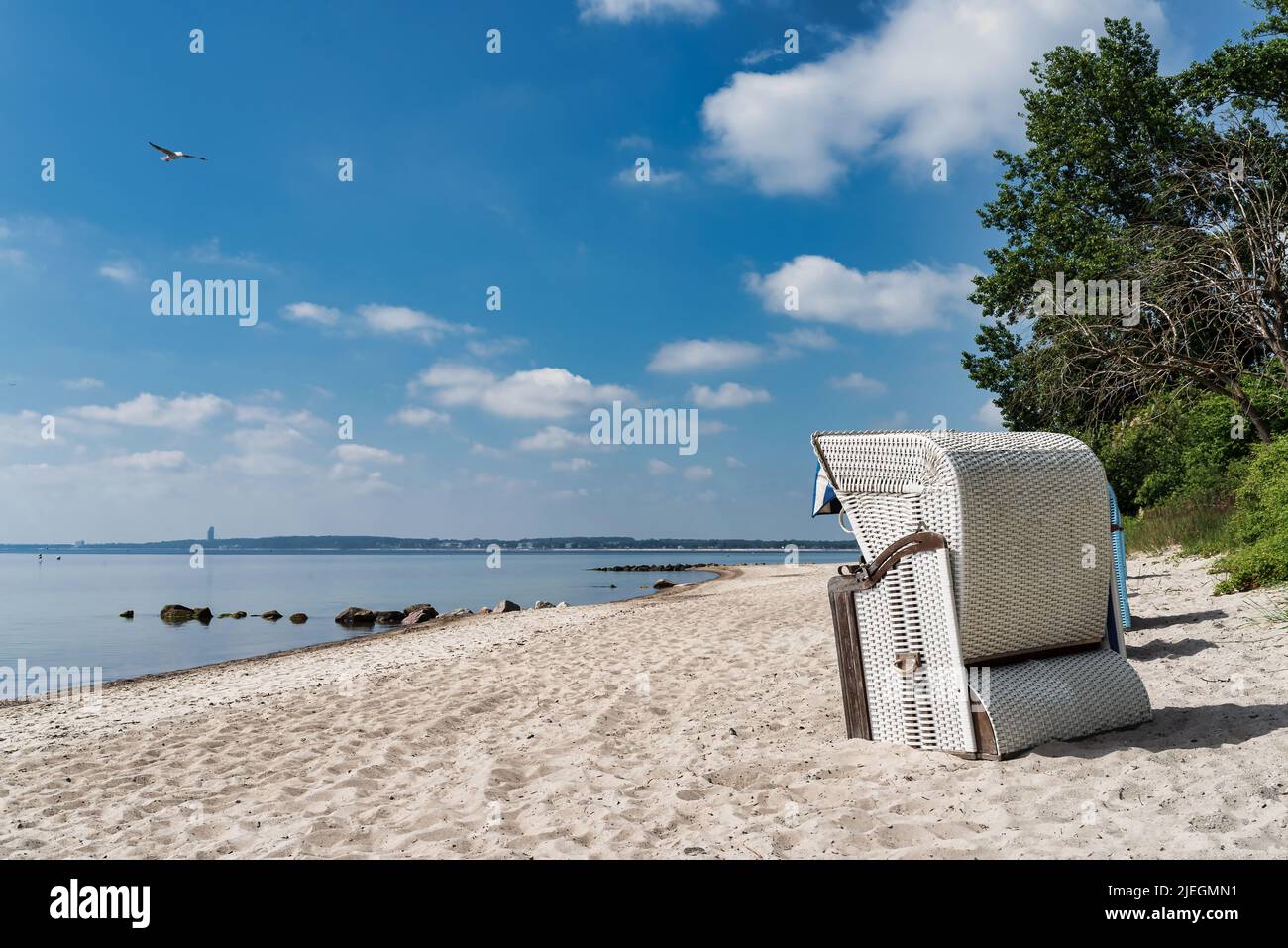traditional canopied beach chair on beautiful baltic sea beach on sunny day Stock Photo