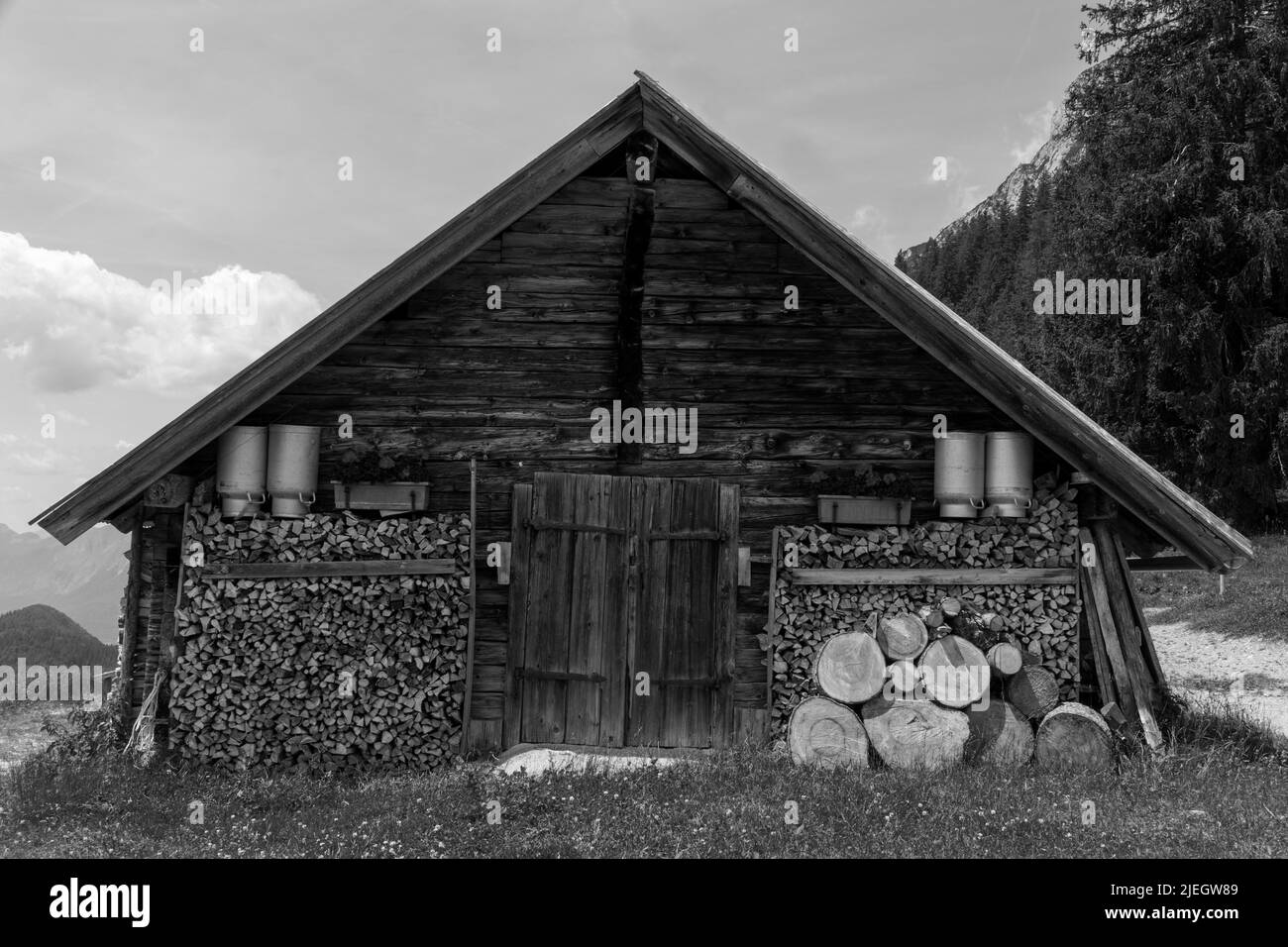 Scheffau, Austria - June 18, 2022 Wooden hut of Steiner Hochalm in black and white Stock Photo