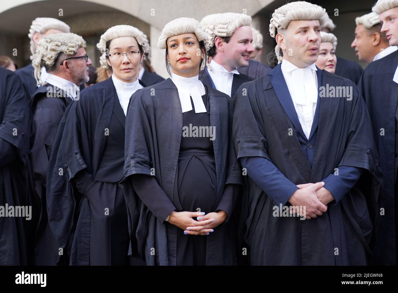 Criminal barristers from the Criminal Bar Association (CBA), which represents barristers in England and Wales, outside the Old Bailey, central London, on the first of several days of court walkouts by CBA members in a row over legal aid funding.Picture date: Monday June 27, 2022. Stock Photo