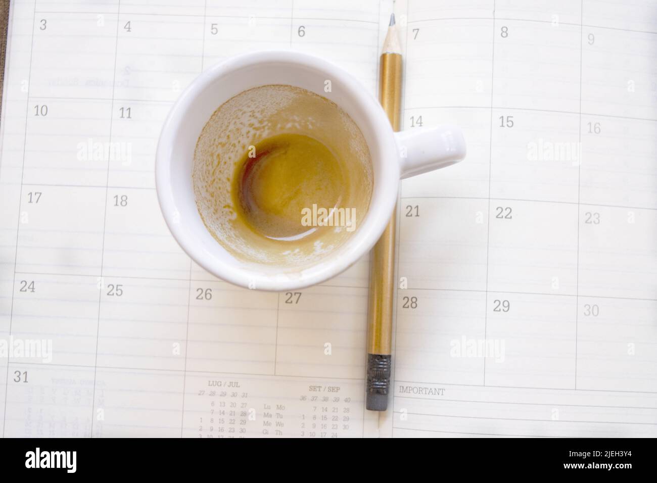 empty cup of coffee on a work diary Stock Photo