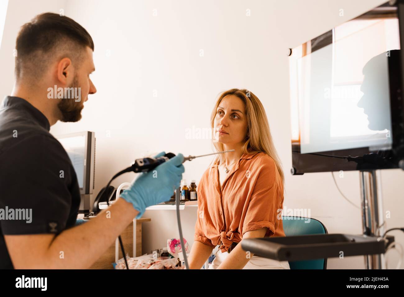 Doctor otolaryngologist with rhinoscope for endoscopy. Consultation