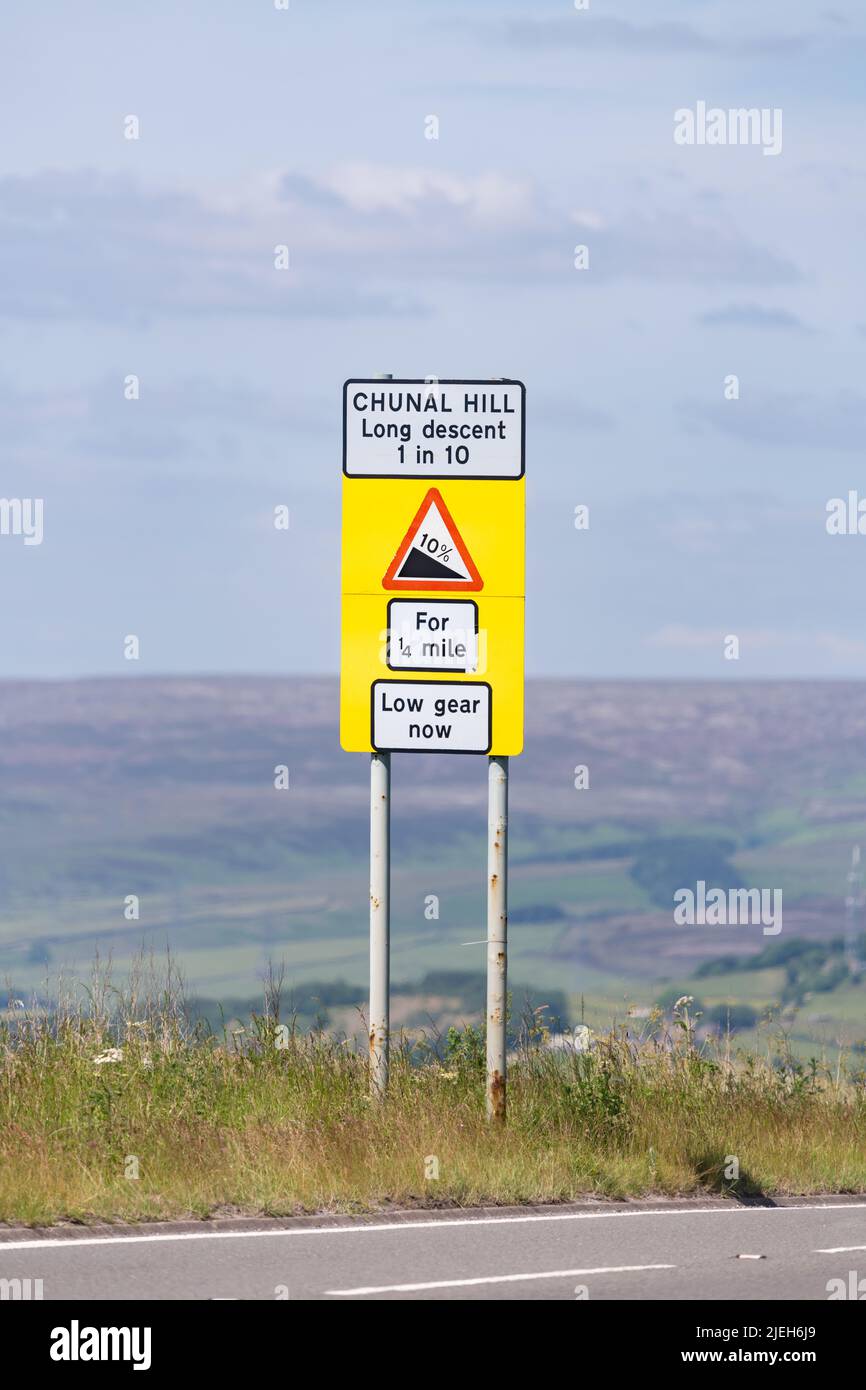 Chunal Hill A624 long descent 1 in 10 low gear now sign, Chunal, Glossop, England, UK Stock Photo