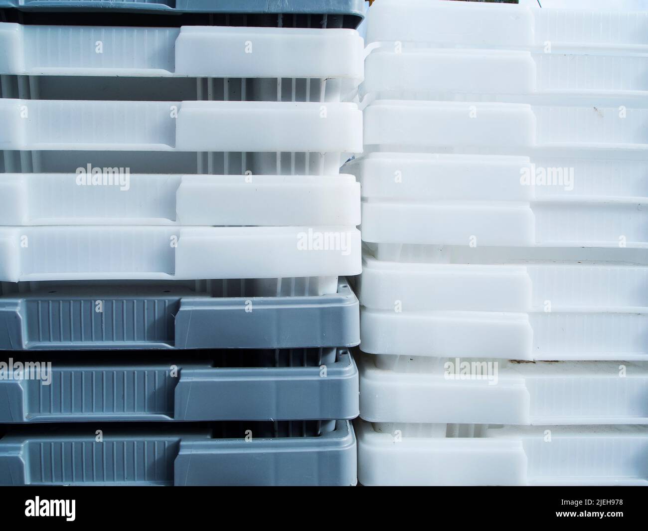 Close-up view of white and gray plastic containers stacked inside. Stock Photo