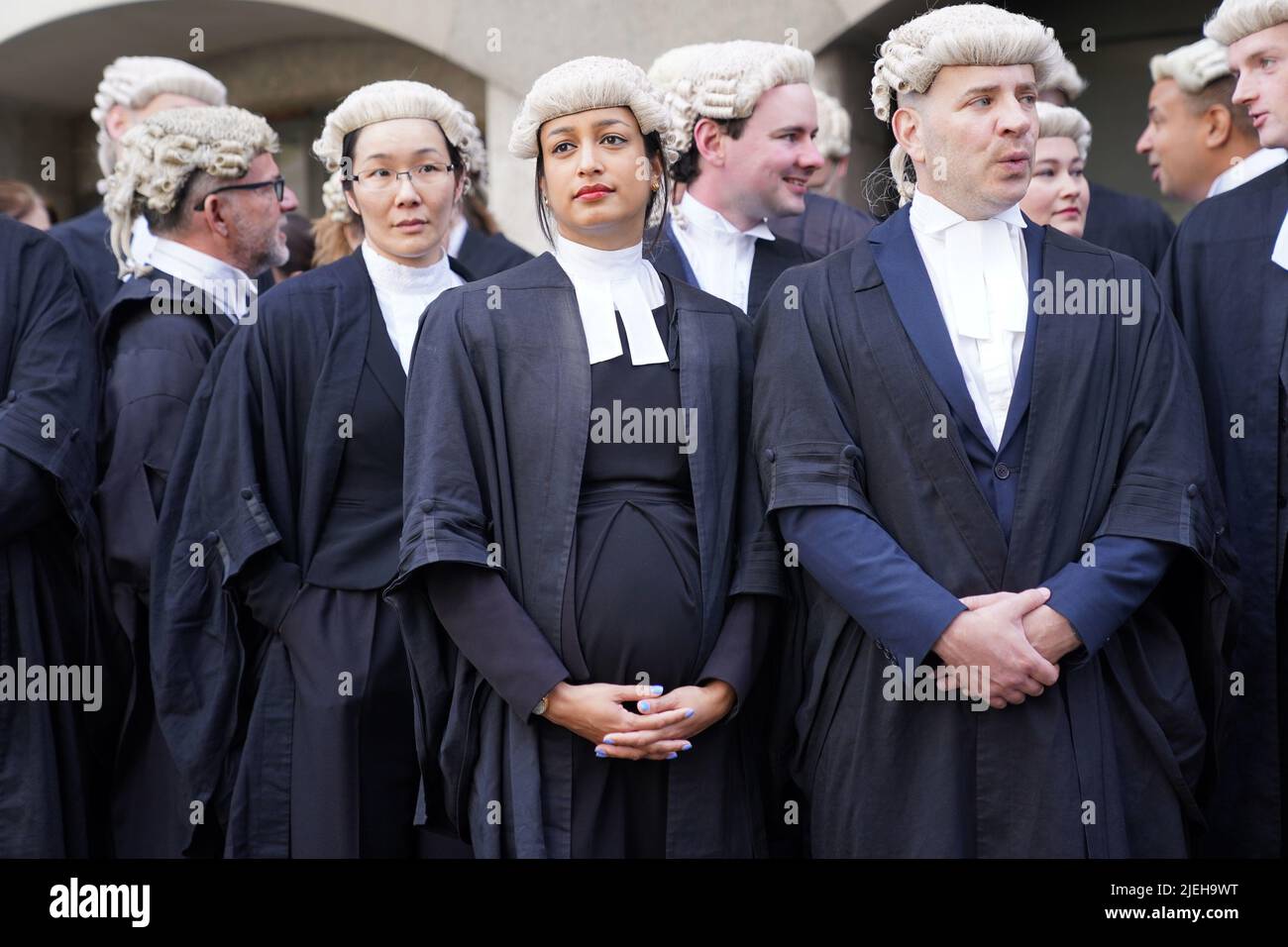 Criminal barristers from the Criminal Bar Association (CBA), which represents barristers in England and Wales, outside the Old Bailey, central London, on the first of several days of court walkouts by CBA members in a row over legal aid funding.Picture date: Monday June 27, 2022. Stock Photo