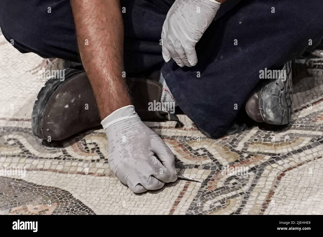 Lod, Israel. 27th June, 2022. Workers conduct last minute cleanup before the Israel Antiquities Authority inaugurates the Shelby White and Leon Levy Lod Mosaic Archaeological Center. The center's goal is to display a 1,710 square foot, Roman period (3rd to 4th century CE) mosaic which served as the floor of a living room villa in a wealthy housing complex in Lod. Credit: Nir Alon/Alamy Live News Stock Photo