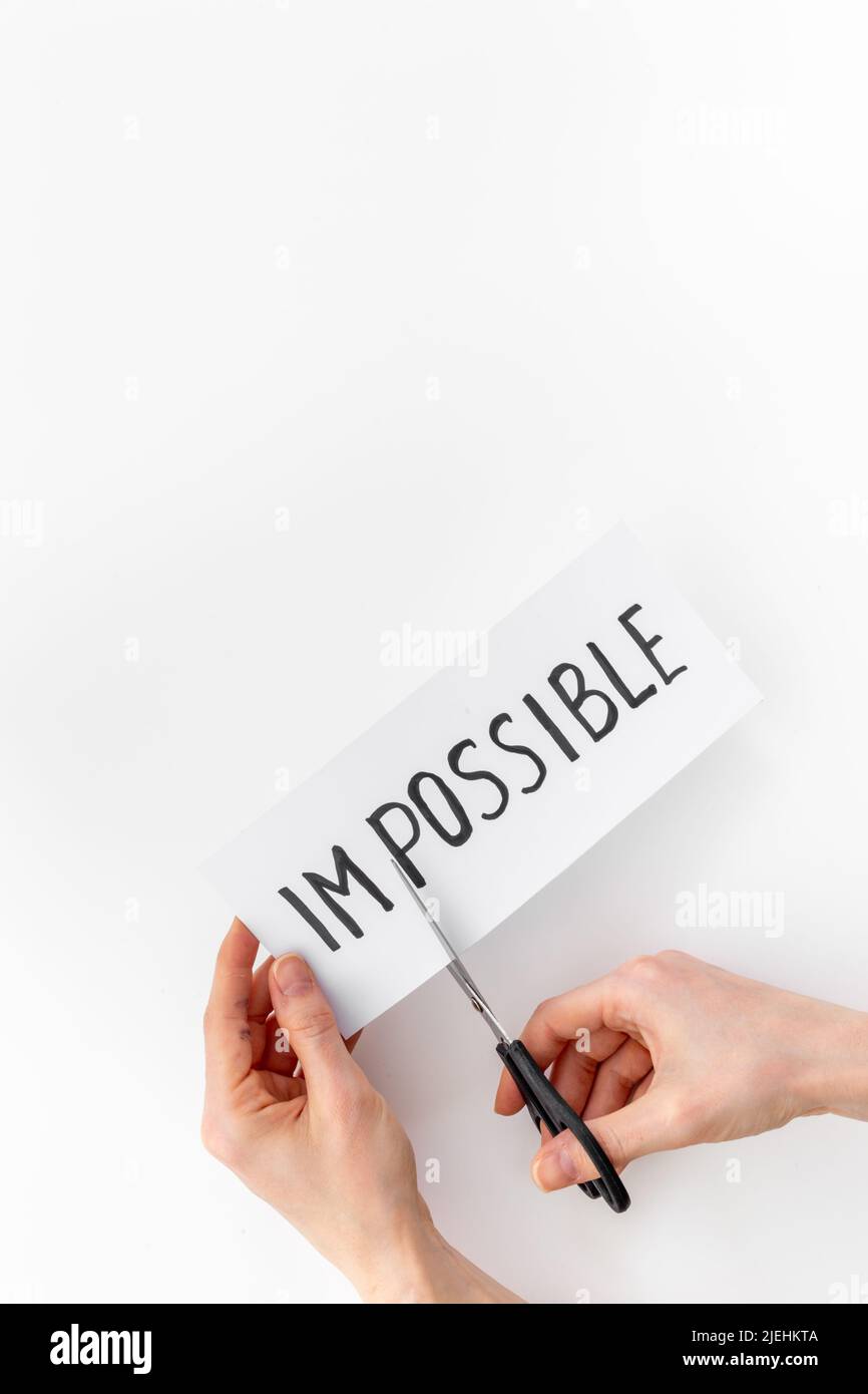 Hands changing word impossible to possible with scissors. Selfmade ...