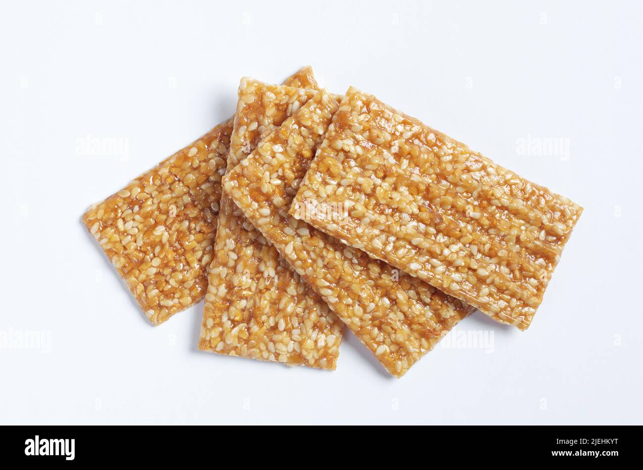 Sesame seed honey bar on white background close up, top view Stock