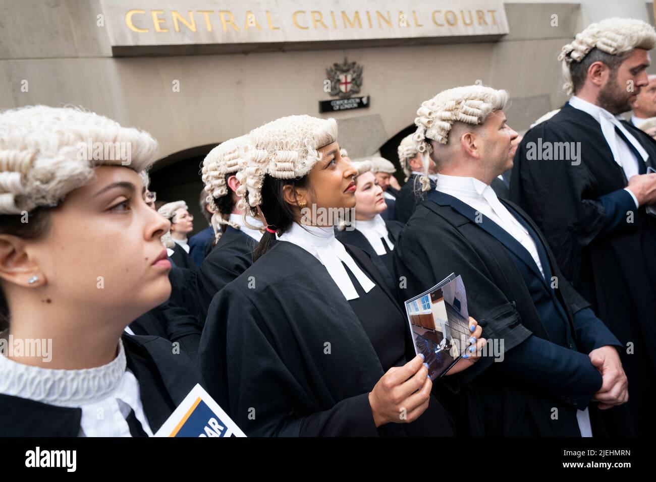 Criminal barristers from the Criminal Bar Association (CBA), which represents barristers in England and Wales, outside the Old Bailey, central London, on the first of several days of court walkouts by CBA members in a row over legal aid funding. Picture date: Monday June 27, 2022. Stock Photo
