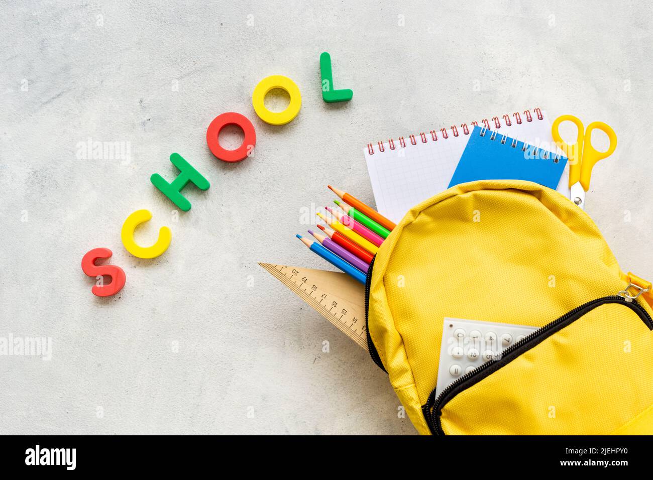 School backpack with school items and students equipment, top view Stock Photo