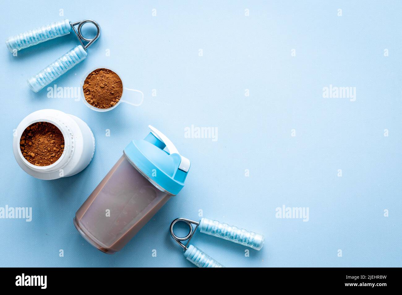 Whey protein powder in jar with shaker for mixing. Fitness and gym diet