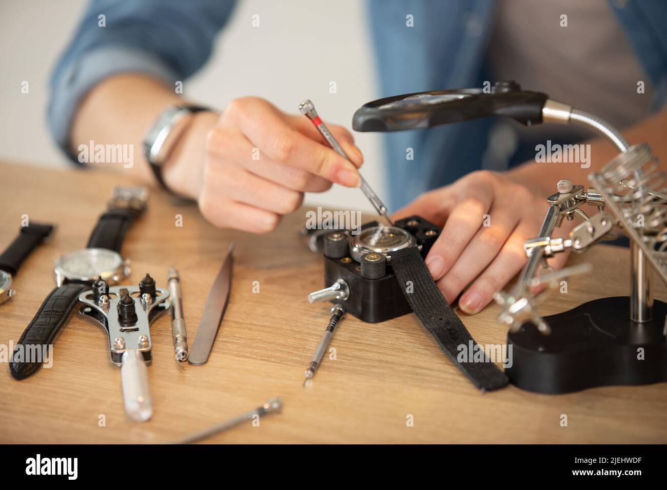 pocket watch being repaired by senior watch maker closeup Stock Photo