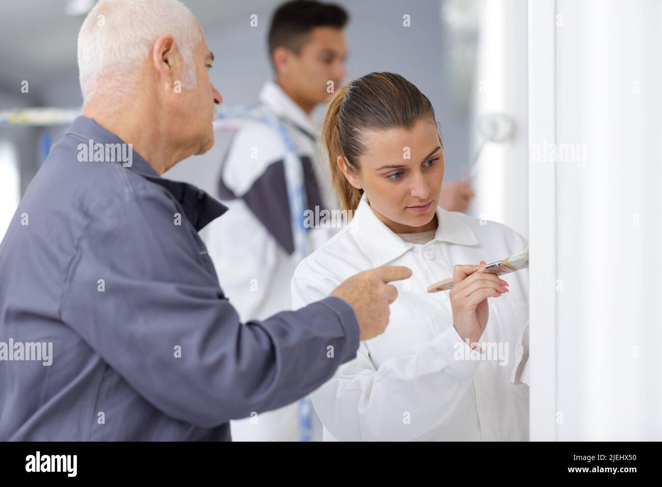 painter with apprentice and client Stock Photo
