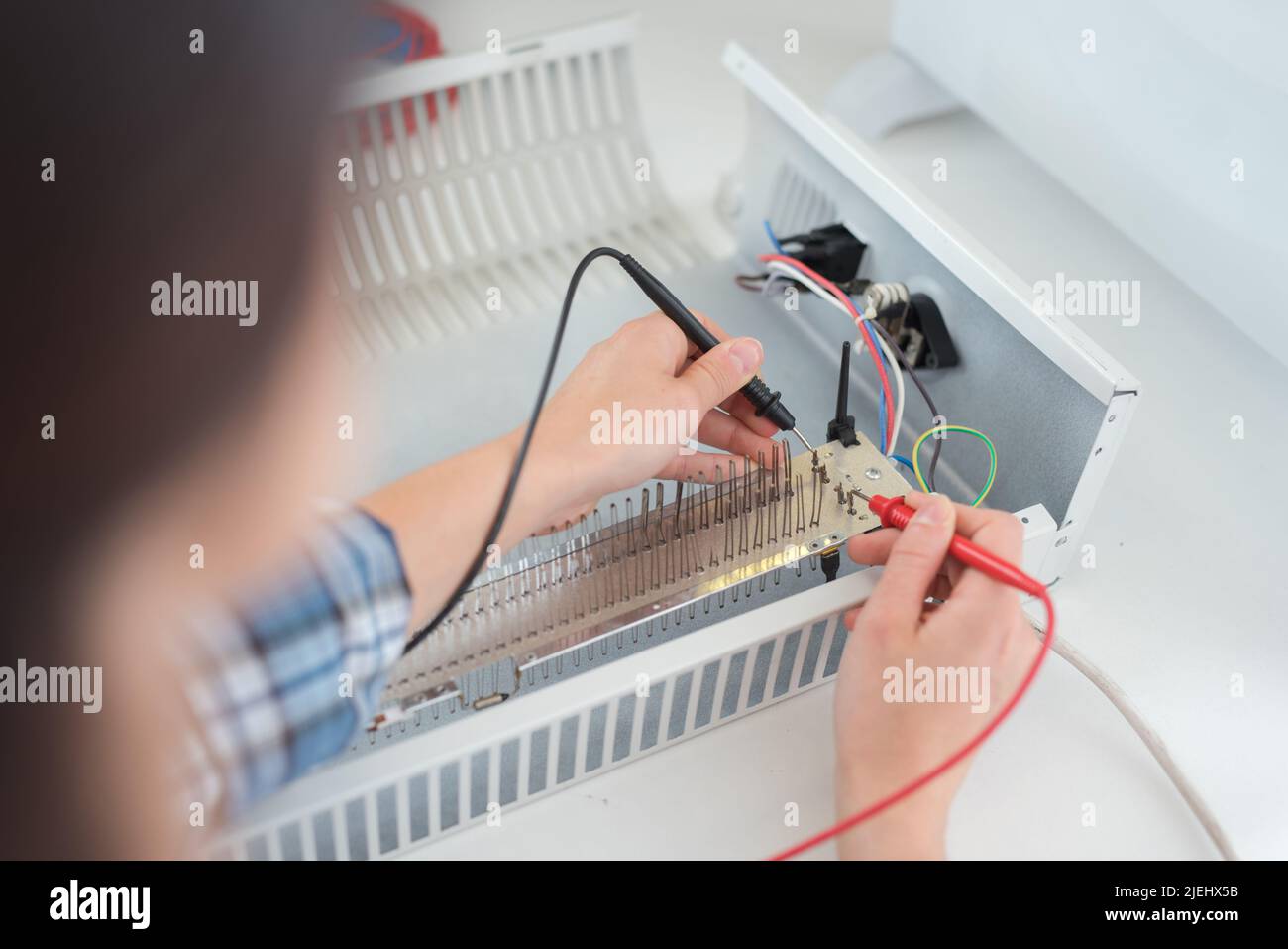 multimeter probes testing heater element Stock Photo Alamy