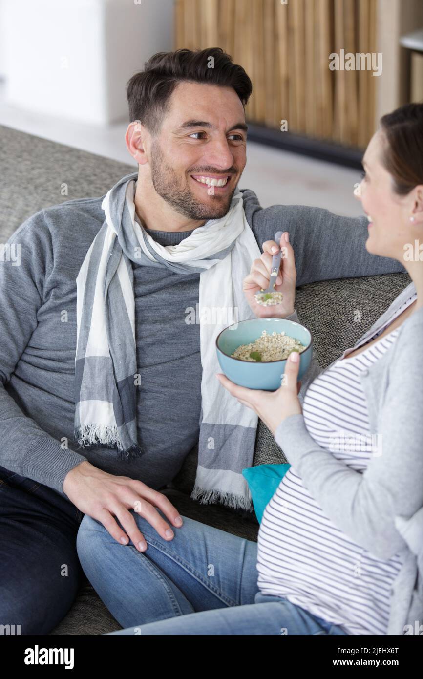 young pregnant couple having cereals Stock Photo