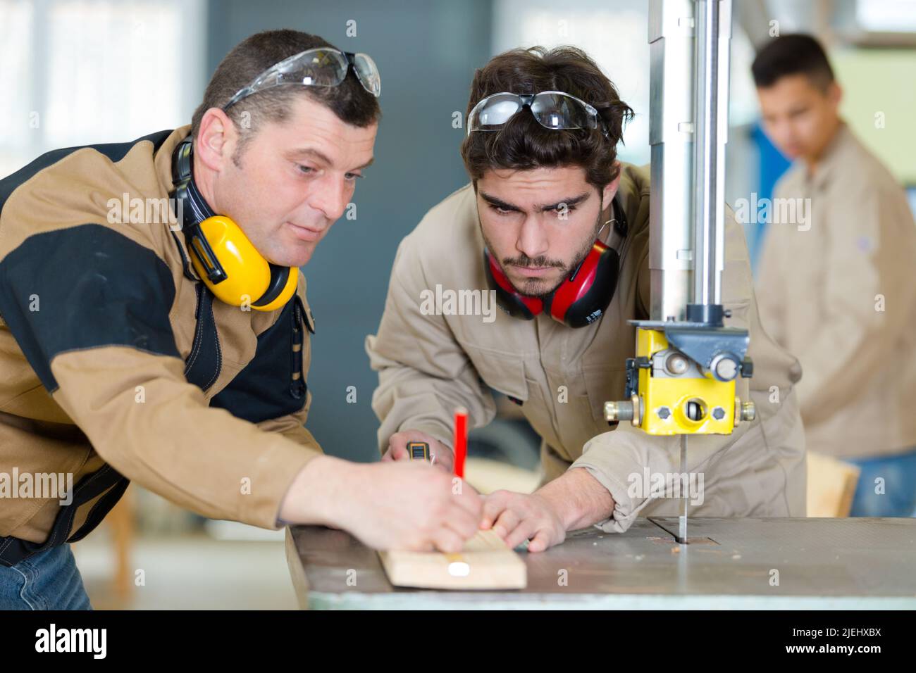 two carpenters are talking while working Stock Photo