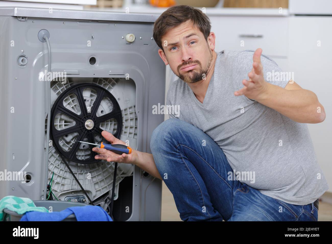 handyman trying to washing machine Stock Photo