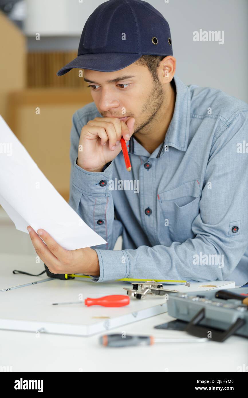 an electrician looking at papers Stock Photo Alamy