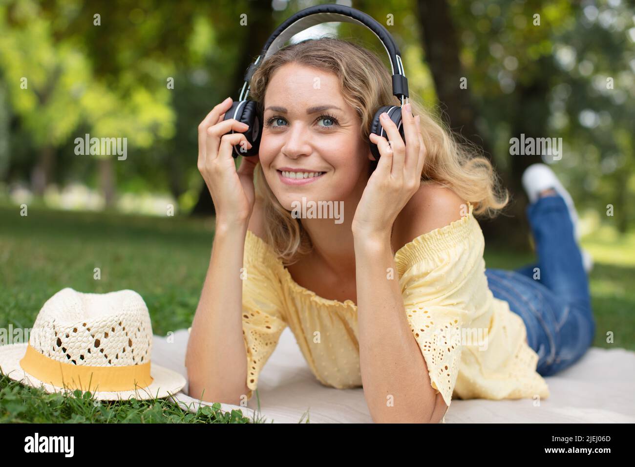 attractive young woman laying down on a park green grass Stock Photo ...