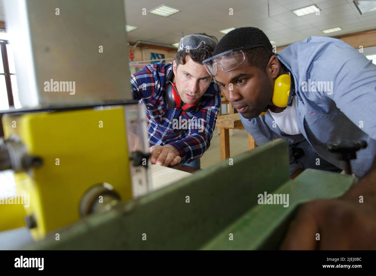 carpenter with apprentice cutting wood in Stock Photo Alamy