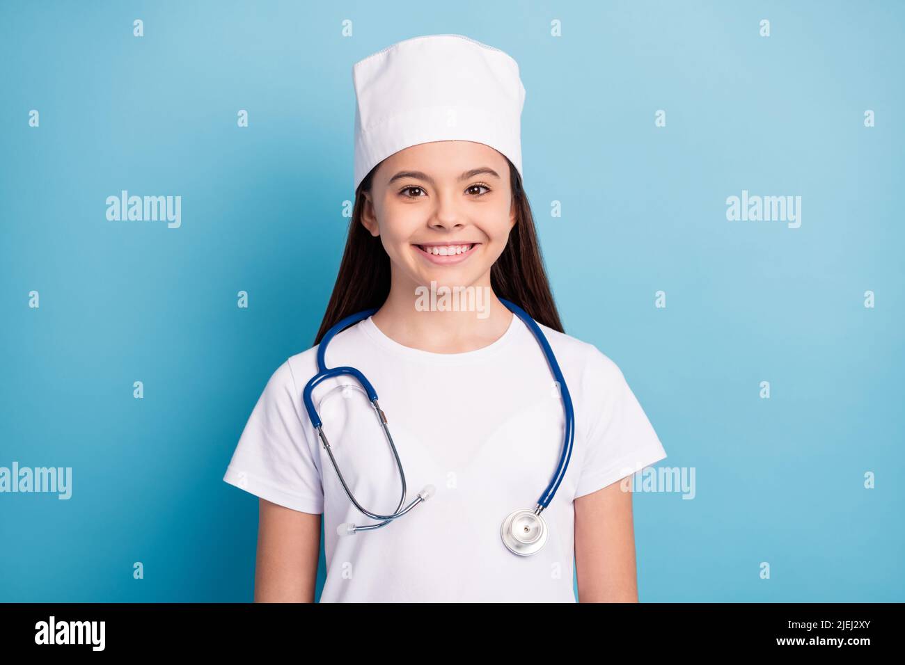 Photo portrait of little girl in medical uniform headwear smiling with ...