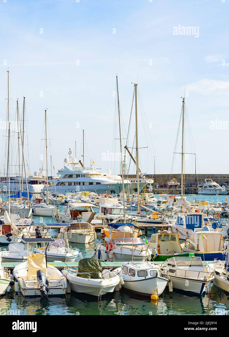 Motorboats and yachts moored in marina, bright sunshine day, Italy Stock Photo