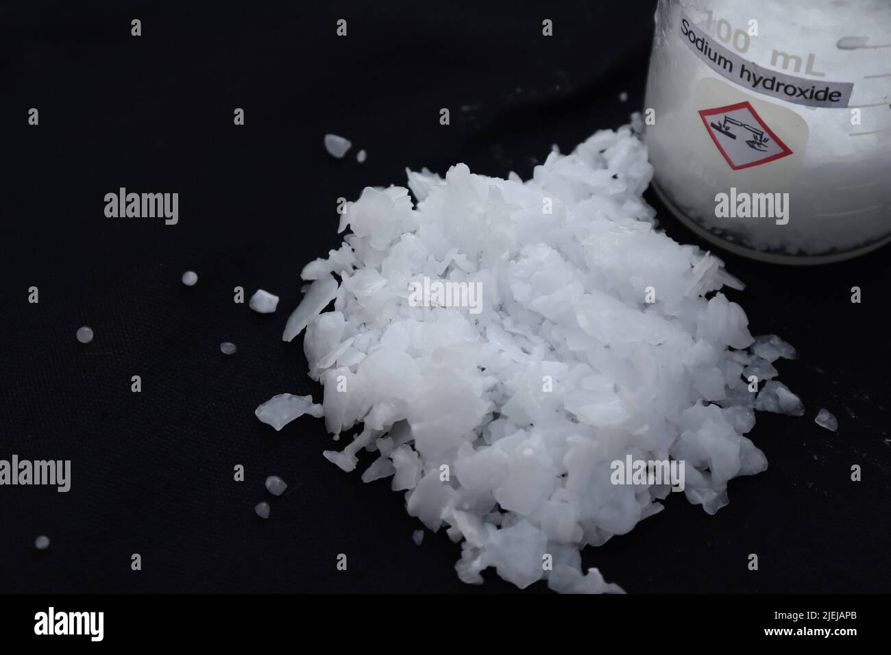 caustic soda flake on black background Stock Photo Alamy
