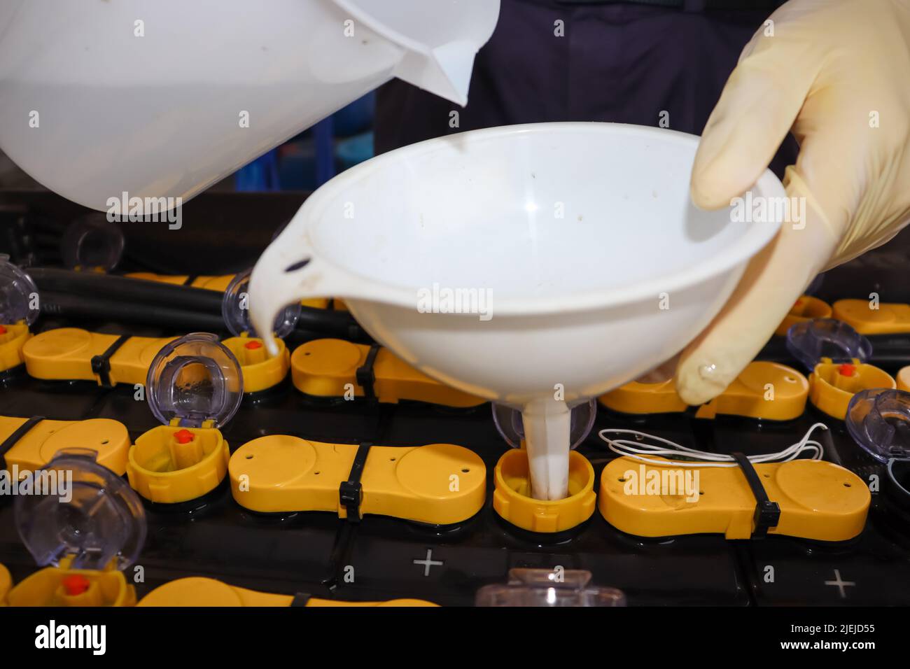 Adjust the battery distilled water level Stock Photo Alamy