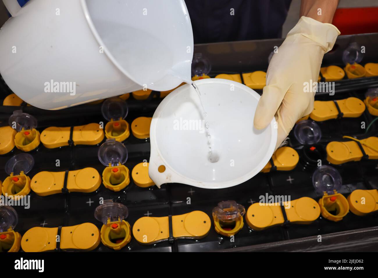 Adjust the battery distilled water level Stock Photo Alamy