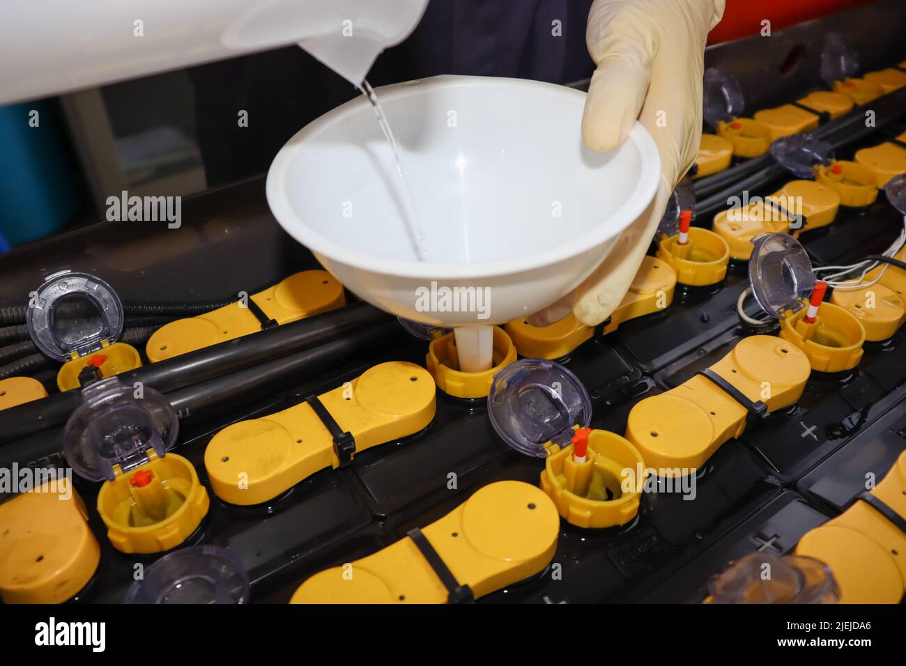 Adjust the battery distilled water level Stock Photo Alamy