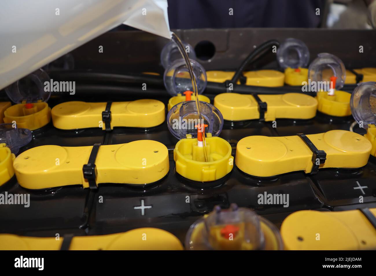 Adjust the battery distilled water level Stock Photo Alamy